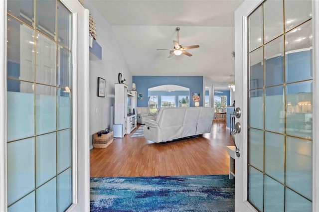 8231 Coral Creek Loop, Hudson, FL 34667 - bedroom with wood finished floors, arched walkways, vaulted ceiling, and a ceiling fan