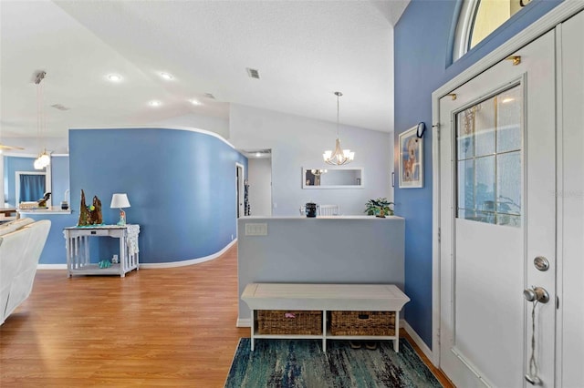8231 Coral Creek Loop, Hudson, FL 34667 - foyer with lofted ceiling, light wood-type flooring, a chandelier, baseboards, and recessed lighting