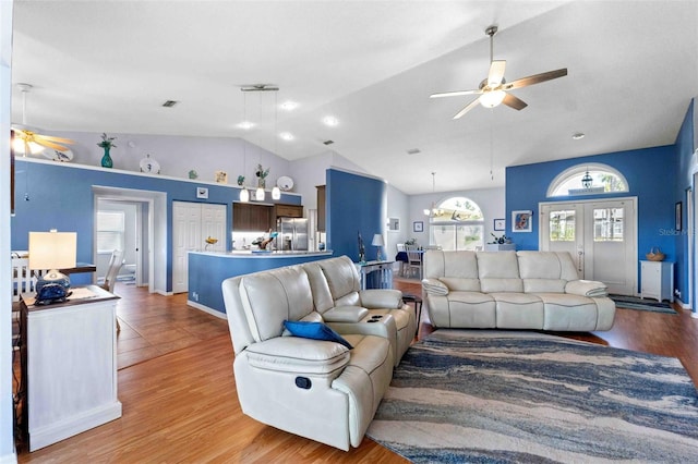 8231 Coral Creek Loop, Hudson, FL 34667 - living area featuring ceiling fan, vaulted ceiling, and light wood-style flooring