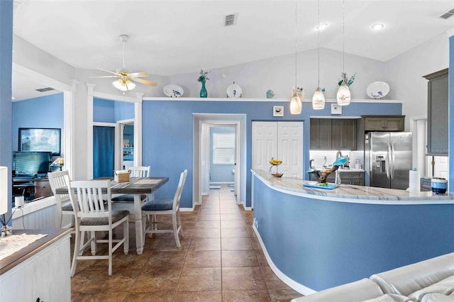 8231 Coral Creek Loop, Hudson, FL 34667 - kitchen featuring stainless steel fridge, a ceiling fan, lofted ceiling, hanging light fixtures, and baseboards