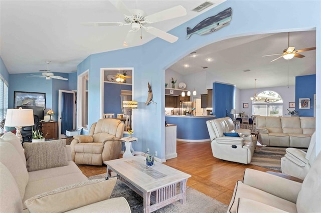 8231 Coral Creek Loop, Hudson, FL 34667 - living area with ceiling fan, lofted ceiling, arched walkways, and wood finished floors