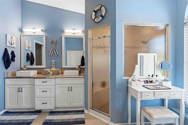 8231 Coral Creek Loop, Hudson, FL 34667 - bathroom with a stall shower, double vanity, and wood finished floors