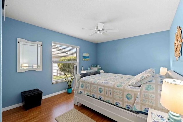 8231 Coral Creek Loop, Hudson, FL 34667 - bedroom featuring wood finished floors, baseboards, and ceiling fan