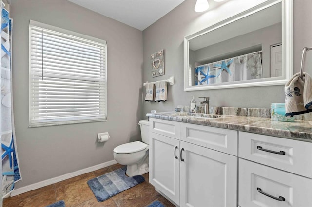 8231 Coral Creek Loop, Hudson, FL 34667 - full bathroom featuring toilet, vanity, baseboards, tile patterned floors, and a shower with curtain