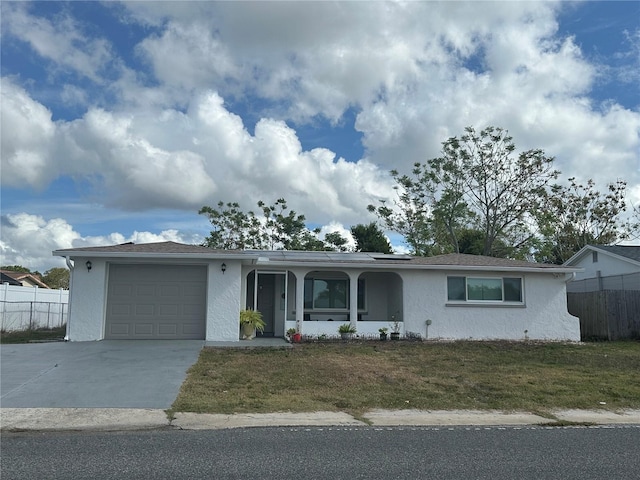 single story home featuring a front lawn and a garage