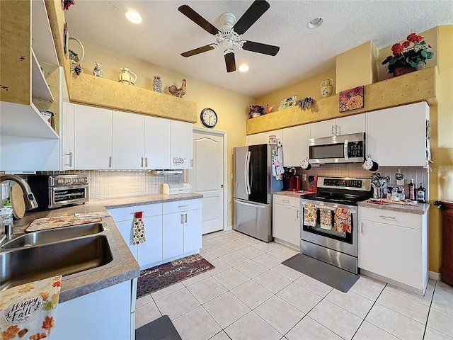 kitchen featuring white cabinetry, light tile patterned flooring, and stainless steel appliances