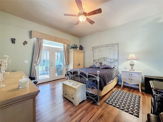 bedroom with hardwood / wood-style flooring, ceiling fan, a textured ceiling, access to exterior, and french doors