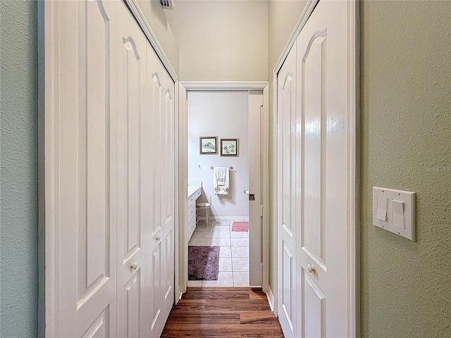 hallway with wood-type flooring