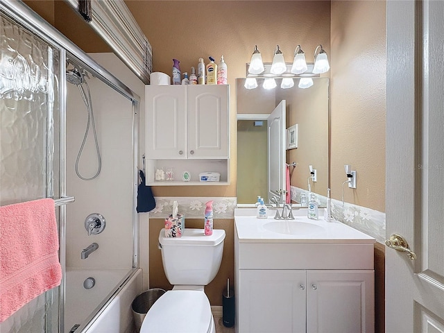 full bathroom with enclosed tub / shower combo, vanity, and toilet