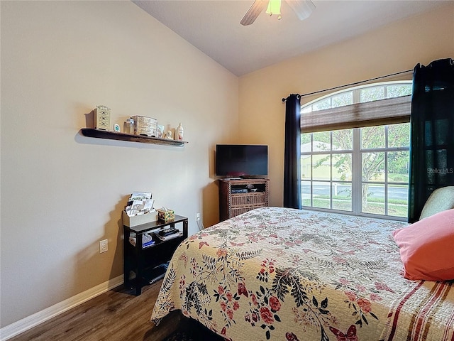 bedroom featuring hardwood / wood-style floors, ceiling fan, and lofted ceiling