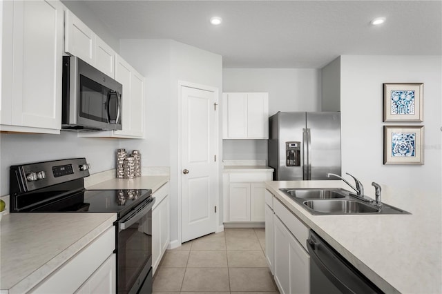 kitchen featuring white cabinetry, sink, and appliances with stainless steel finishes