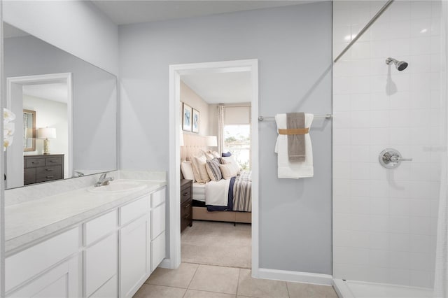 bathroom featuring tile patterned flooring, vanity, and a tile shower