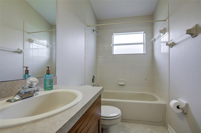 full bathroom featuring tile patterned flooring, vanity, tiled shower / bath combo, and toilet