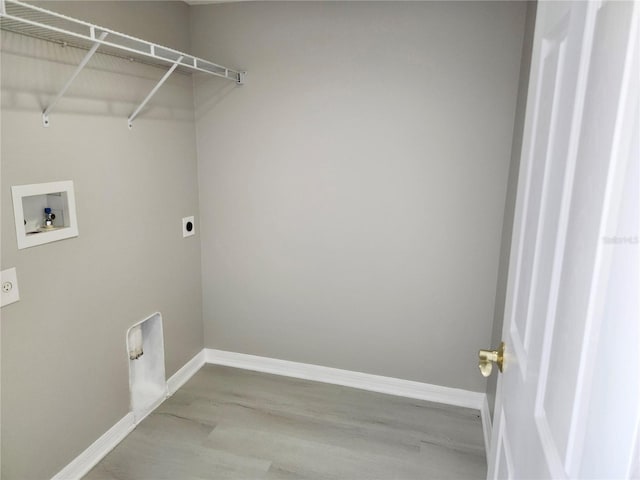 clothes washing area with hookup for an electric dryer, light wood-type flooring, and washer hookup