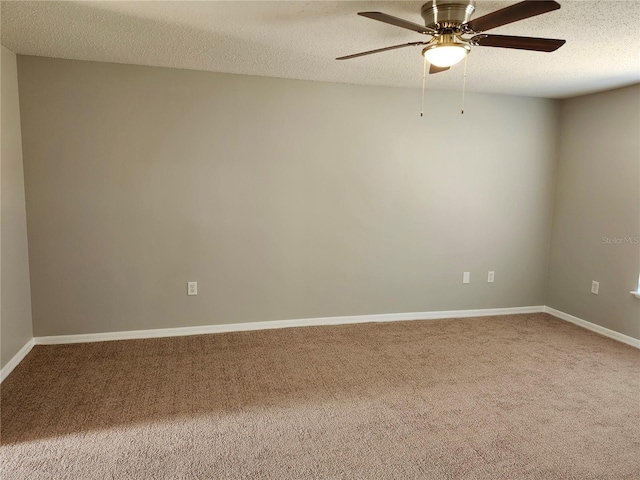 carpeted spare room with a textured ceiling and ceiling fan