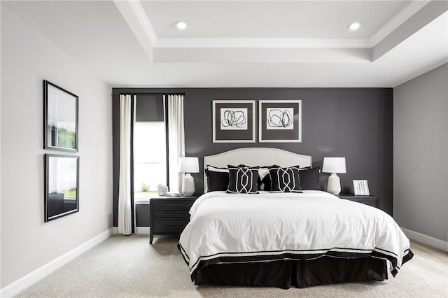 carpeted bedroom with a raised ceiling and crown molding