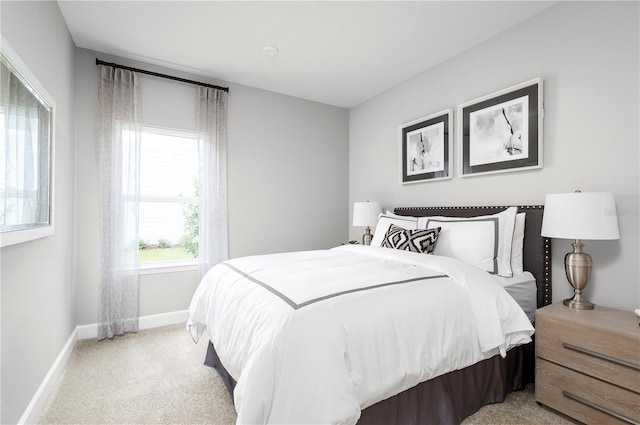 bedroom featuring light colored carpet