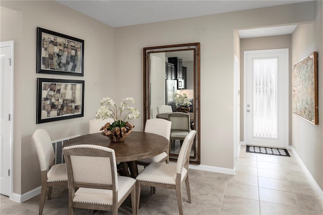 dining area with a wealth of natural light and light tile patterned flooring