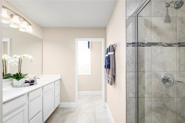 bathroom featuring vanity, tile patterned flooring, and a shower with door