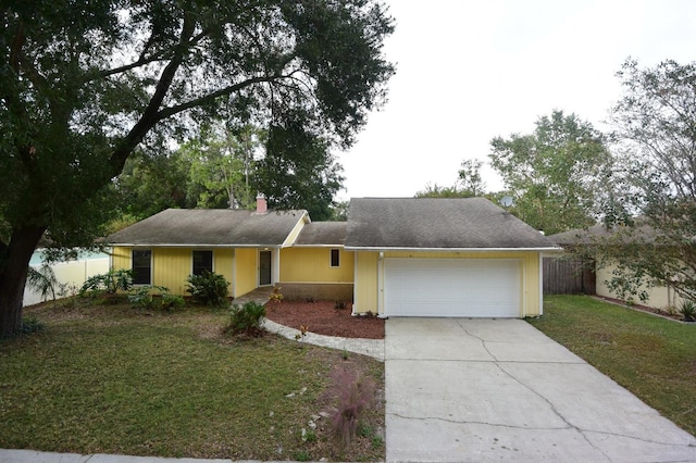 ranch-style home with a garage and a front yard