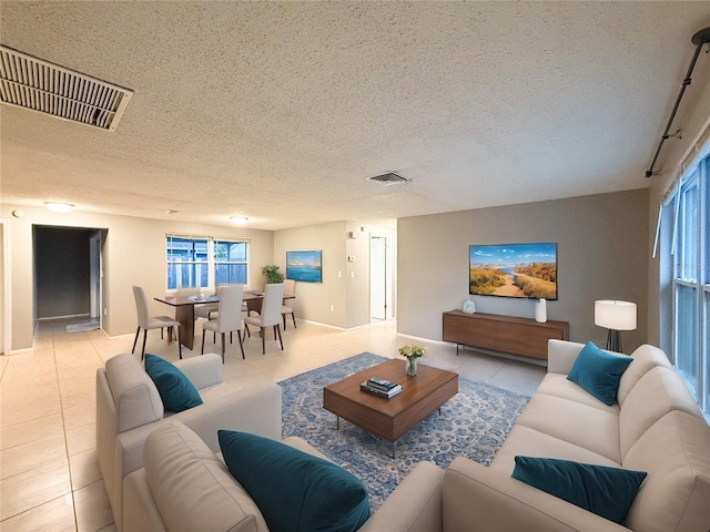 6417 Sutherland Ave, New Port Richey, FL 34653 - living area featuring a textured ceiling and light tile patterned floors