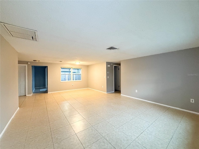 spare room featuring light tile patterned flooring