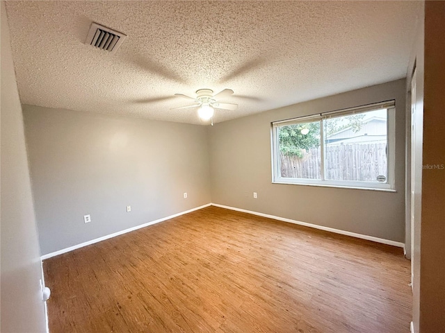 6417 Sutherland Ave, New Port Richey, FL 34653 - spare room featuring wood finished floors, ceiling fan, baseboards, and a textured ceiling