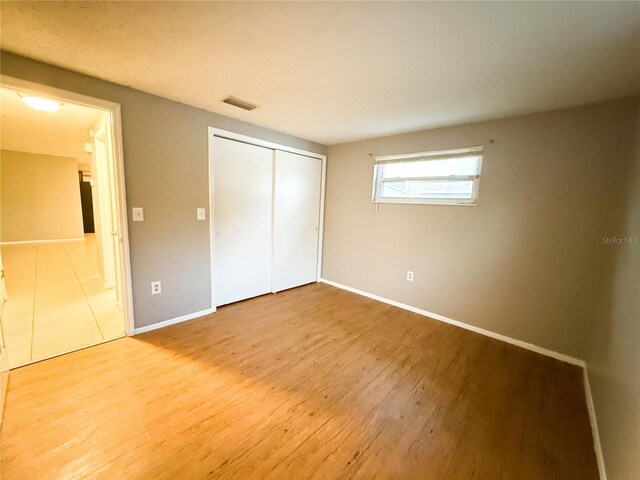 6417 Sutherland Ave, New Port Richey, FL 34653 - unfurnished bedroom featuring wood finished floors, baseboards, and a closet