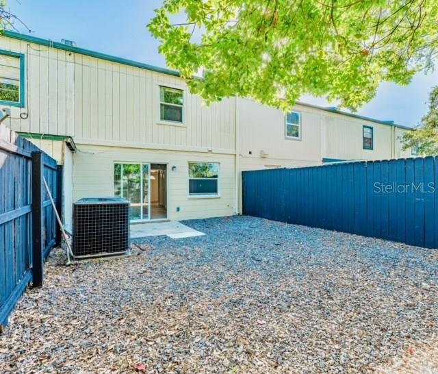 rear view of property with central AC and a patio