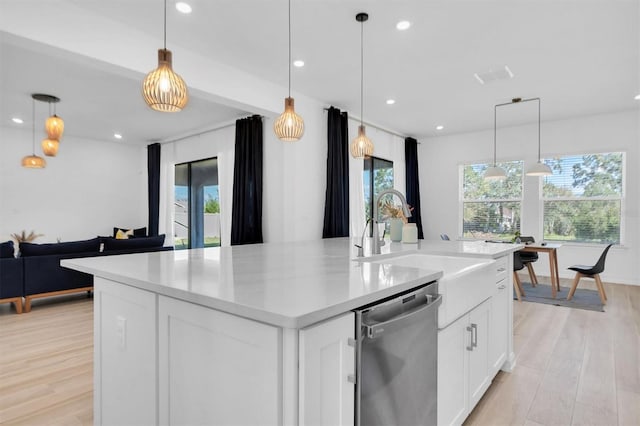 kitchen featuring a wealth of natural light, dishwasher, and pendant lighting