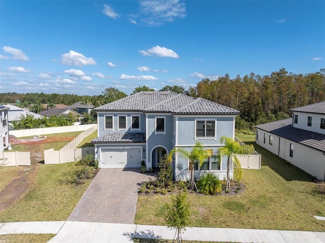 view of front of home with a front yard and a garage