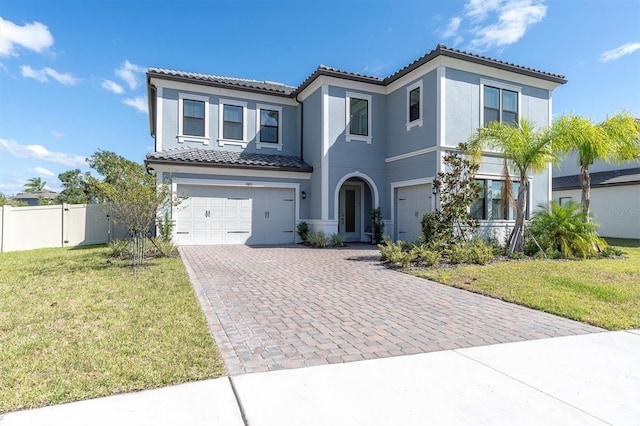 mediterranean / spanish home with a front lawn and a garage