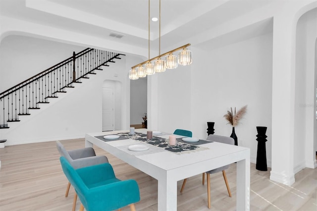 dining area with a notable chandelier and light wood-type flooring