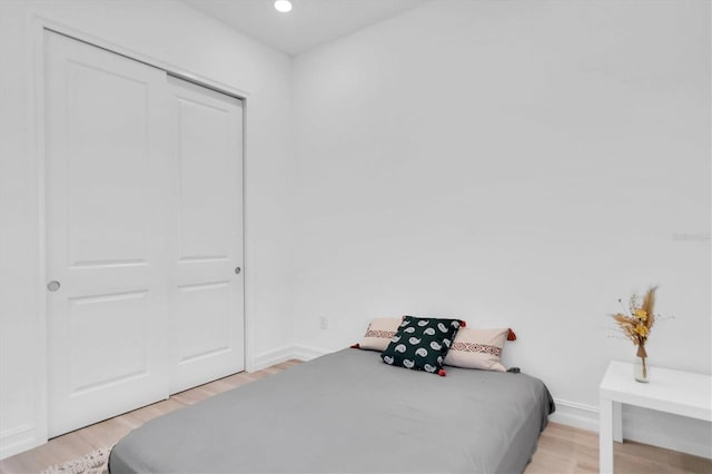 bedroom featuring light hardwood / wood-style floors and a closet