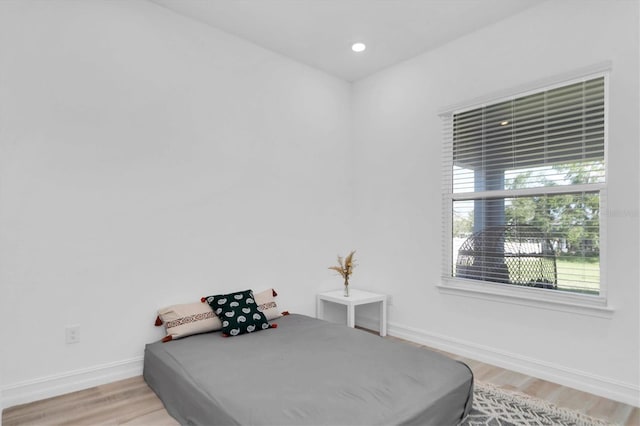 bedroom with hardwood / wood-style flooring