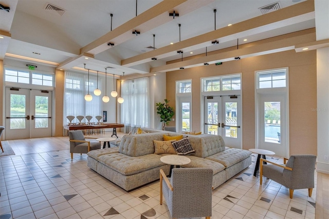 tiled living room featuring french doors, a wealth of natural light, and a high ceiling