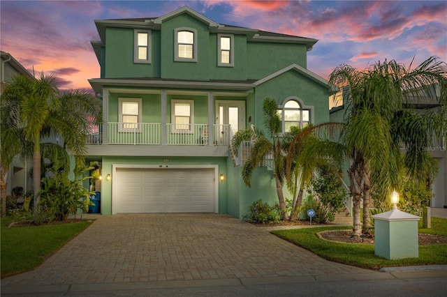 view of front of house featuring a garage and a balcony