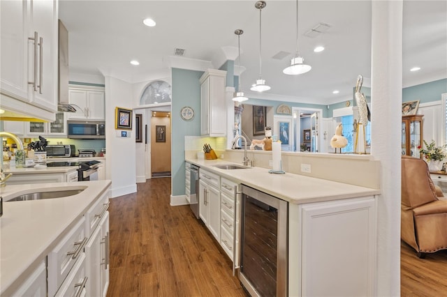 kitchen featuring wine cooler, stainless steel appliances, sink, and white cabinets