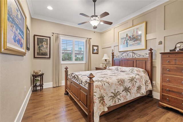 bedroom featuring ceiling fan, ornamental molding, and hardwood / wood-style floors