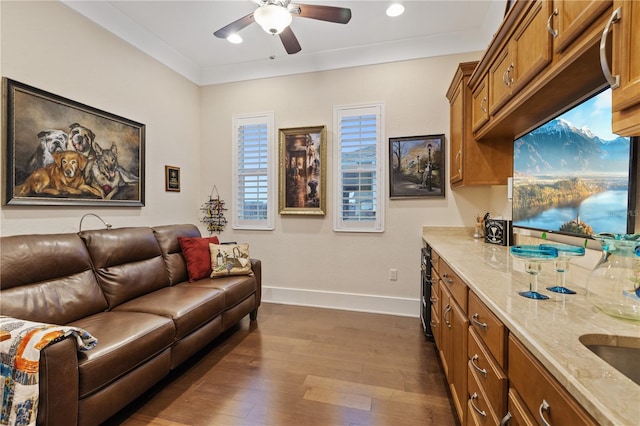 living room featuring crown molding, dark hardwood / wood-style floors, and ceiling fan