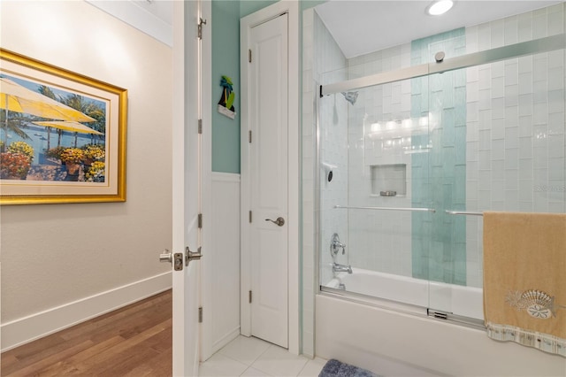 bathroom featuring tile patterned floors and shower / bath combination with glass door