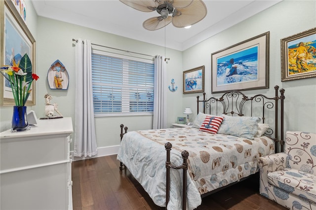 bedroom with ceiling fan, ornamental molding, and dark hardwood / wood-style flooring