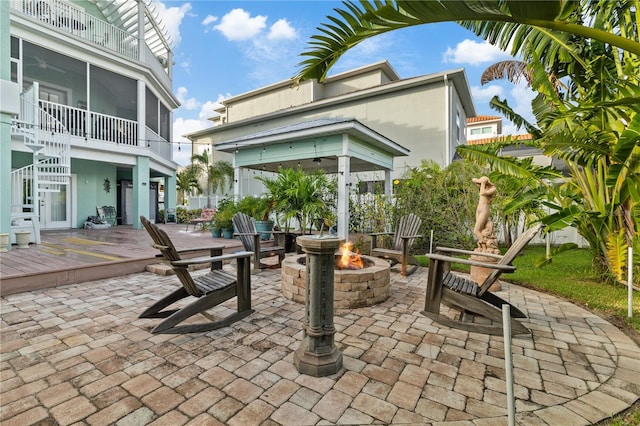 view of patio with a wooden deck and an outdoor fire pit