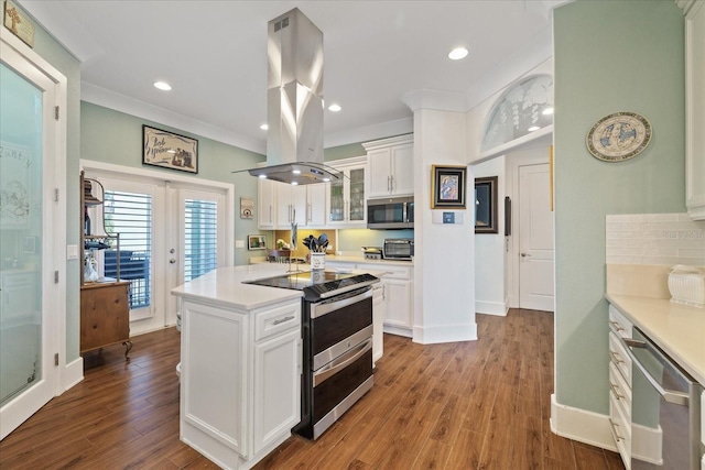 kitchen with stainless steel appliances, island exhaust hood, wood-type flooring, and white cabinets