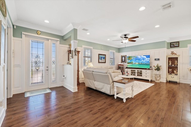 living room with ornamental molding, dark hardwood / wood-style floors, and ceiling fan