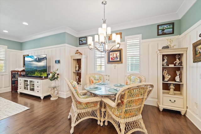 dining area featuring ornamental molding, a notable chandelier, and dark hardwood / wood-style flooring