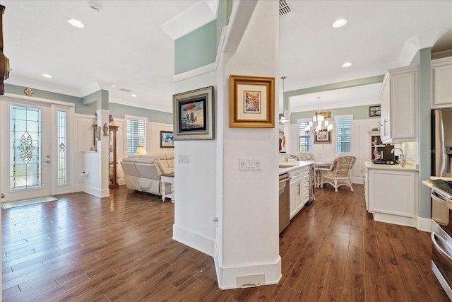 kitchen with hanging light fixtures, dark hardwood / wood-style floors, and white cabinets