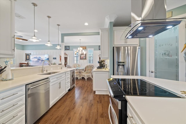 kitchen featuring sink, white cabinetry, decorative light fixtures, island exhaust hood, and stainless steel appliances