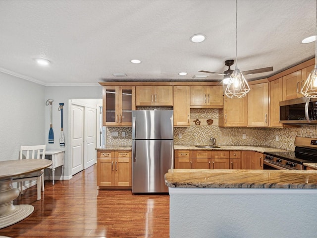 kitchen featuring stainless steel appliances, backsplash, decorative light fixtures, crown molding, and light wood-type flooring