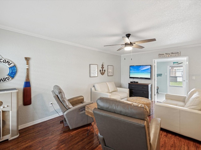 living room featuring dark wood-type flooring, a textured ceiling, ceiling fan, and crown molding